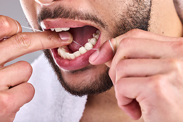 Image showing Mouth, dental and man floss teeth in studio isolated on a background for healthy hygiene. Tooth, flossing product and closeup of male model cleaning for oral wellness, fresh breath and gums.