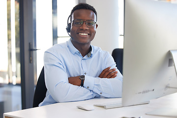 Image showing Arms crossed, portrait and a black man at a desk in a call center for online support and service. Smile, pride and an African customer care employee at a computer for telemarketing or sales help