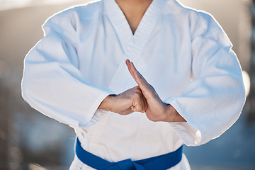 Image showing Sport, fitness and fighting with a karate man in gi, training in the city on a blurred background. Exercise, discipline or respect with a male athlete during a self defense workout for health closeup