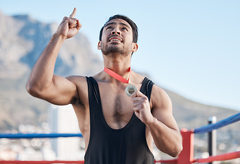 Image showing Winning, boxing medal and a man with thanks to God, celebration and sports gratitude. Success, young and a boxer with pride and award from a sport competition and grateful to commitment of a prize