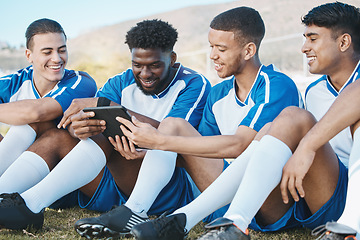 Image showing Soccer player, team or group with a tablet outdoor on field for fitness training or online game. Football, club and diversity athlete people or friends with tech to watch sports competition or video