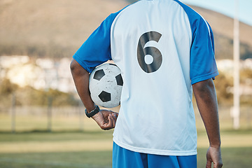 Image showing Sports, soccer ball and man with player number on a field for exercise, fitness and training outdoor. Football club, pitch and game with back of athlete person for professional sport competition