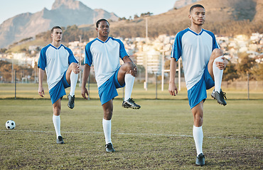 Image showing Soccer, sports and team stretching legs on a field for fitness, exercise and training outdoor. Football ball, pitch and club of athlete men together for sport competition, diversity or muscle warm up