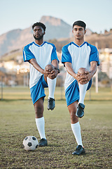 Image showing Football, team sports and stretching legs on field for fitness, exercise and training outdoor. Soccer ball, pitch and diversity athlete men together for sport competition, workout or muscle warm up