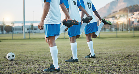 Image showing Soccer, team sports and stretching legs on field for fitness, exercise and training outdoor. Football ball, pitch and club for athlete men together for sport competition, wellness and muscle warm up