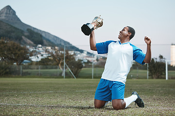 Image showing Soccer player, sports and man celebrate trophy on field for competition game outdoor. Black male athlete champion excited for football prize, award and win or sport achievement and success on a pitch