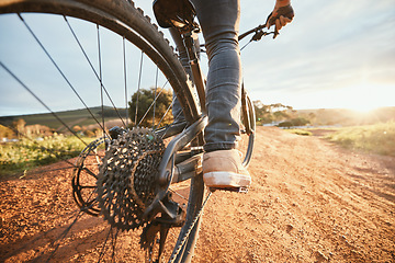 Image showing Feet, cycling and a man on a bike and dirt road for fitness, morning cardio or adventure in nature. Sports, tire and a person on a bicycle for a race, competition or exercise in the countryside