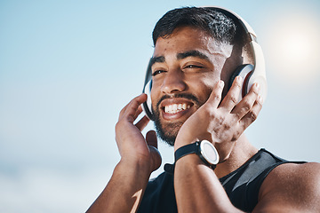 Image showing Thinking, beach and a man with music for fitness, running motivation and ideas in nature. Smile, wellness and an athlete listening or streaming a podcast while training or exercise vision at the sea