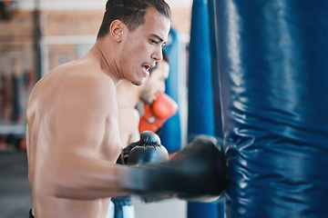 Image showing Sports, boxing and man with punching bag in gym for training, cardio workout and exercise. Fitness, body builder and male athlete with equipment for boxer competition, practice and mma performance
