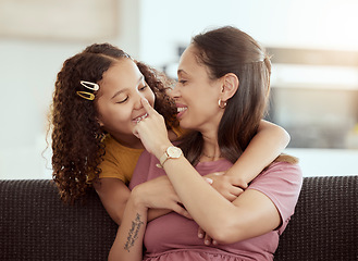 Image showing Hug, love and mother with girl on a sofa, playing and happy in their home together, sweet and care. Family, embrace and child with parent in living room, smile and hugging while having fun on weekend