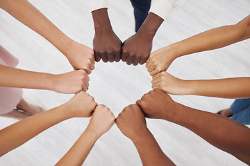 Image showing Hands, collaboration and overhead with a business team standing in a circle for unity or solidarity at work. Teamwork, fist bump and support with a diverse group of colleagues in a huddle from above