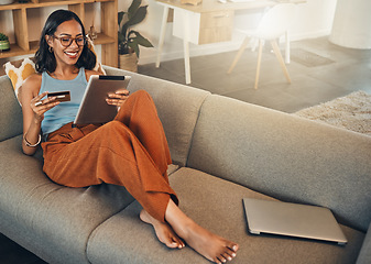 Image showing Ecommerce, credit card and woman on a sofa, tablet and transactions with online shopping, home and relax. Female person, happy client or customer on a sofa, technology or buying with internet banking