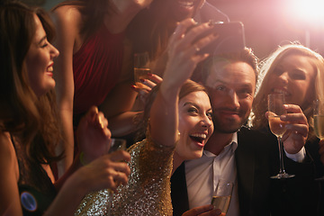 Image showing Selfie, party and new year with friends in a nightclub posing for photograph of celebration together. Champagne, toast and nightlife with a group of people taking a picture in a club while dancing