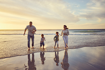Image showing Beach, sunset and parents play with kids on holiday, summer vacation and weekend together. Nature, family and happy mother, father and children run in ocean for bonding, adventure and quality time