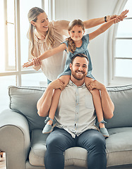 Image showing Happy family, portrait and child on sofa with flying game, piggy back and play in living room for man and woman. Mother, father and kid playing airplane games on couch with smile, happiness and love.