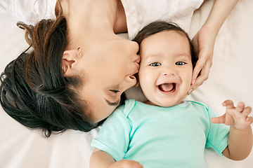 Image showing Top view, bed and mother kiss baby for bonding, quality time or loving support together at home. Newborn face, portrait or above of mom and happy infant for care, relationship or affection in bedroom