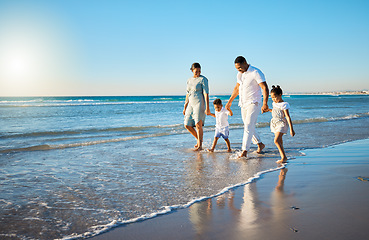 Image showing Family travel, beach walking and holding hands with mother, father and kids at ocean on holiday. Vacation and parent care with mockup in summer outdoor with mom, dad and children by sea having fun