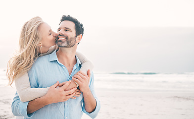 Image showing Beach, love and couple hug and kiss on holiday, vacation and romantic weekend for anniversary. Mockup space, marriage and mature man embrace woman for bonding, quality time and happiness by ocean