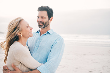 Image showing Beach, hug and couple with smile in nature on holiday, vacation and romantic weekend for anniversary. Love, marriage and happy mature man hugging woman for bonding, quality time and relax by ocean