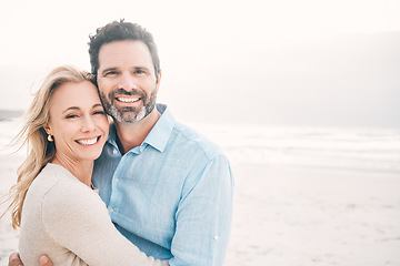 Image showing Travel, hug and portrait of couple on beach with smile on holiday, vacation and weekend for anniversary. Love, marriage and happy mature man hugging woman for bonding, quality time and relax by ocean
