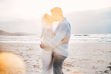 Image showing Beach, lens flare and couple kiss for love on holiday, vacation and romantic weekend for anniversary. Travel, marriage and mature man kissing woman for bonding, quality time and happiness by ocean