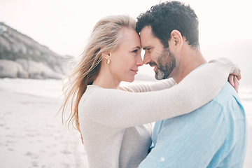 Image showing Beach, love and couple touching head on holiday, vacation and romantic weekend for anniversary. Intimacy, marriage and happy mature man hugging woman for bonding, quality time and happiness by ocean