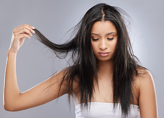 Image showing Hair care, damage and face of woman in studio with worry for split end, haircare crisis and weak strand. Beauty, hairdresser and upset female person with frizz, dry or loss problem on gray background