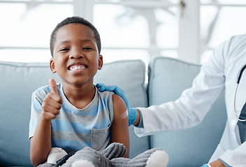 Image showing Boy kid, thumbs up and injection with smile in portrait, plaster and medicine for wellness in hospital. Male child, happy and excited with vaccine, healthcare and brave to stop virus on clinic sofa