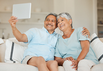 Image showing Technology, selfie and married couple with tablet on a sofa in living room of their home. Happiness, social networking and love with elderly people on an online video call with internet connection