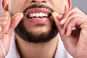 Image showing Mouth, man and flossing teeth for dental health in studio isolated on a white background. Closeup, floss and male model cleaning tooth for oral wellness, hygiene and healthy product for fresh breath.