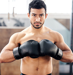 Image showing Portrait, boxer and serious man in gym for exercise, battle and training for fight. Face, boxing and male athlete, fighter or sports person workout, fitness and practice for martial arts challenge.