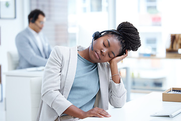 Image showing Call center, tired and woman sleeping with headset for telemarketing, sales or customer service. Black female consultant or agent at crm, tech support or help desk with stress, burnout or fatigue