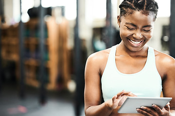 Image showing Happy, black woman with a tablet and in a gym with a smile for inventory. Fitness or workout, training or exercise for motivation and African female athlete smiling for health wellness in sportswear