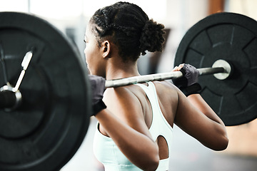 Image showing Black woman, back with weightlifting and fitness, barbell in gym and strong bodybuilder with muscle training. Sport, workout and bodybuilding, female athlete in exercise studio, challenge and power