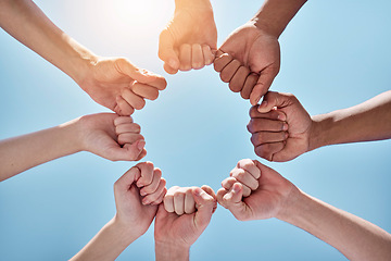 Image showing Team building, fist bump and hands in a circle together for unity, collaboration and connection. Solidarity, diversity and closeup of a group of multiracial people in a round shape by sky background.