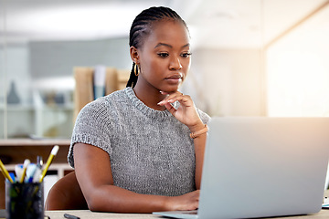 Image showing Laptop, research and a business black woman thinking while working at her desk in her office with flare. Computer, planning and idea with a serious young female employee reading an email at work