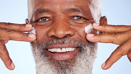 Image showing Beauty, cream and closeup portrait of black man in studio for sunscreen anti aging or skincare. Cosmetics, spa or self care with lotion on face of model on blue background for facial and product