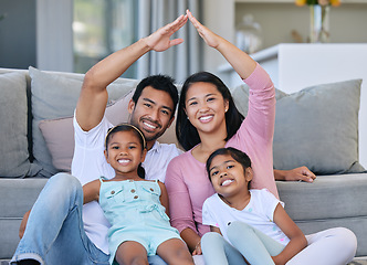 Image showing Hand roof, portrait and family in a house for safety, security and investment. Happy, love and parents and children with hands to cover for family insurance, mortgage or property on the lounge floor