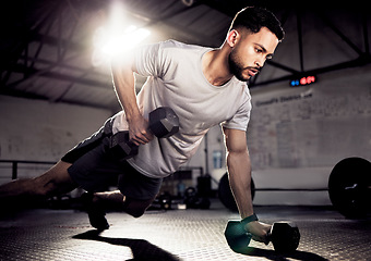 Image showing Fitness, push up and man exercise with dumbbells at gym for training workout with focus. Serious male athlete or bodybuilder with weights for strong muscle, power or motivation for hard work on floor