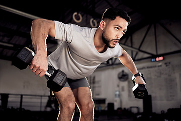 Image showing Fitness, dumbbells and man exercise at gym for training workout with focus. Serious male athlete or bodybuilder with weights for strong muscle, power or motivation for hard work and bent over row