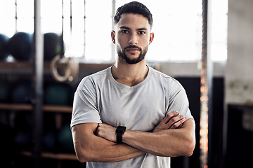 Image showing Fitness, exercise and portrait of a serious man at gym for a training workout with focus. Face of male athlete or personal trainer with strong muscle, power and motivation with arms crossed at club