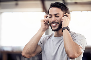 Image showing Headphones, listening to music and a man at gym for exercise, fitness or training workout. Face of happy male athlete listen to audio, sound or radio with tech for motivation, mindset and to relax