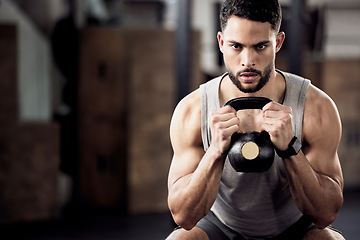 Image showing Fitness, exercise and man squat with a kettlebell at gym for a training workout with focus. Serious male athlete or bodybuilder with weights for strong muscle, power and motivation with mockup space