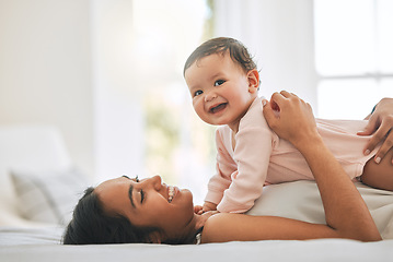 Image showing Mom lying, cuddle newborn and bedroom with smile, care and happiness in morning with love, bond or excited face. Young mother, baby and happy in bed, family home or holding kid with pride together