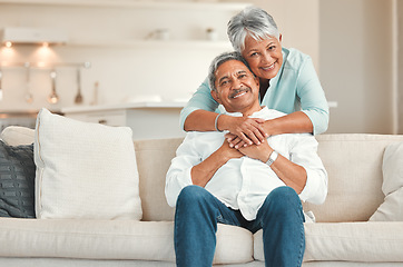 Image showing Senior couple, couch and portrait with hug, smile and love in home living room with care, romance or happiness. Elderly man, old woman and embrace by lounge sofa in relax retirement together in house