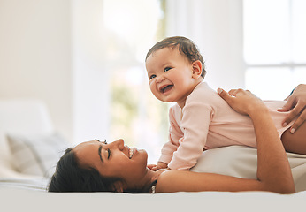 Image showing Mother lying, embrace newborn baby and bed with smile, care or happiness in morning with love, bond or excited face. Young mom, kid and happy in bedroom, family home or holding with pride in sunshine