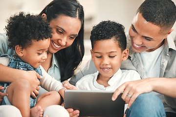 Image showing Young happy family, kids and tablet on couch for game, movie or learning together in home, love and bonding. Parents, education and children on living room sofa with smile, care or app on touchscreen