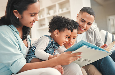 Image showing Young happy family, children reading and sofa for story, book and learning together in home, love and bonding. Parents, education and kids on living room couch with smile, care and support in house