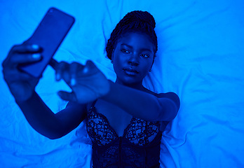 Image showing Sexy selfie, bed and black woman with lighting for a photo for social media or online chat. Above, blue room and an African person taking pictures on a mobile in lingerie for web, an app or sexting