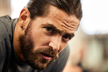 Image showing Tired, portrait and a man in the gym with a break from fitness, breathing and training. Rest, health and face of a person with fatigue after a workout, exercise and catching breath after sports